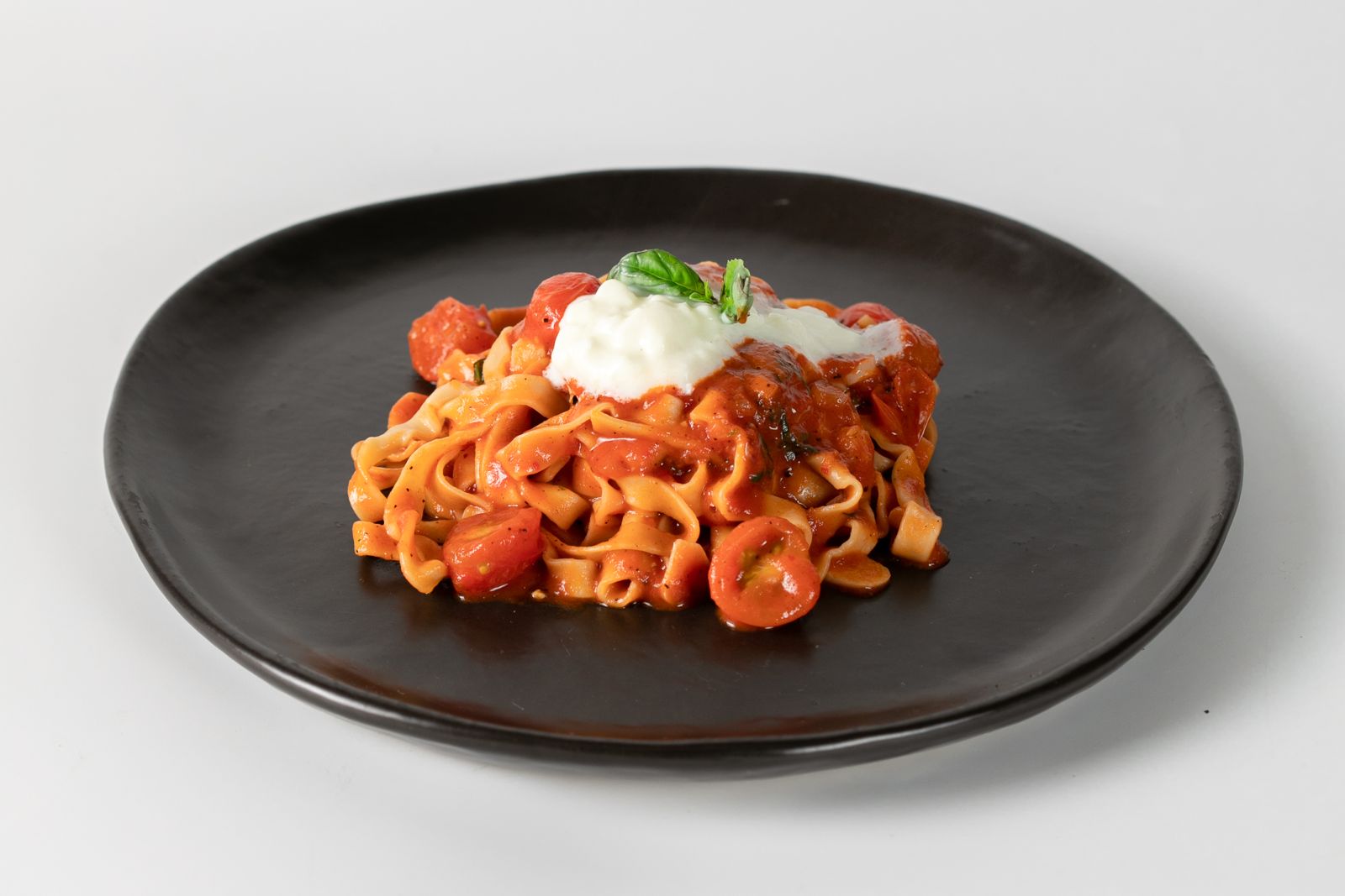 Tomato pasta with fresh cheese and basil